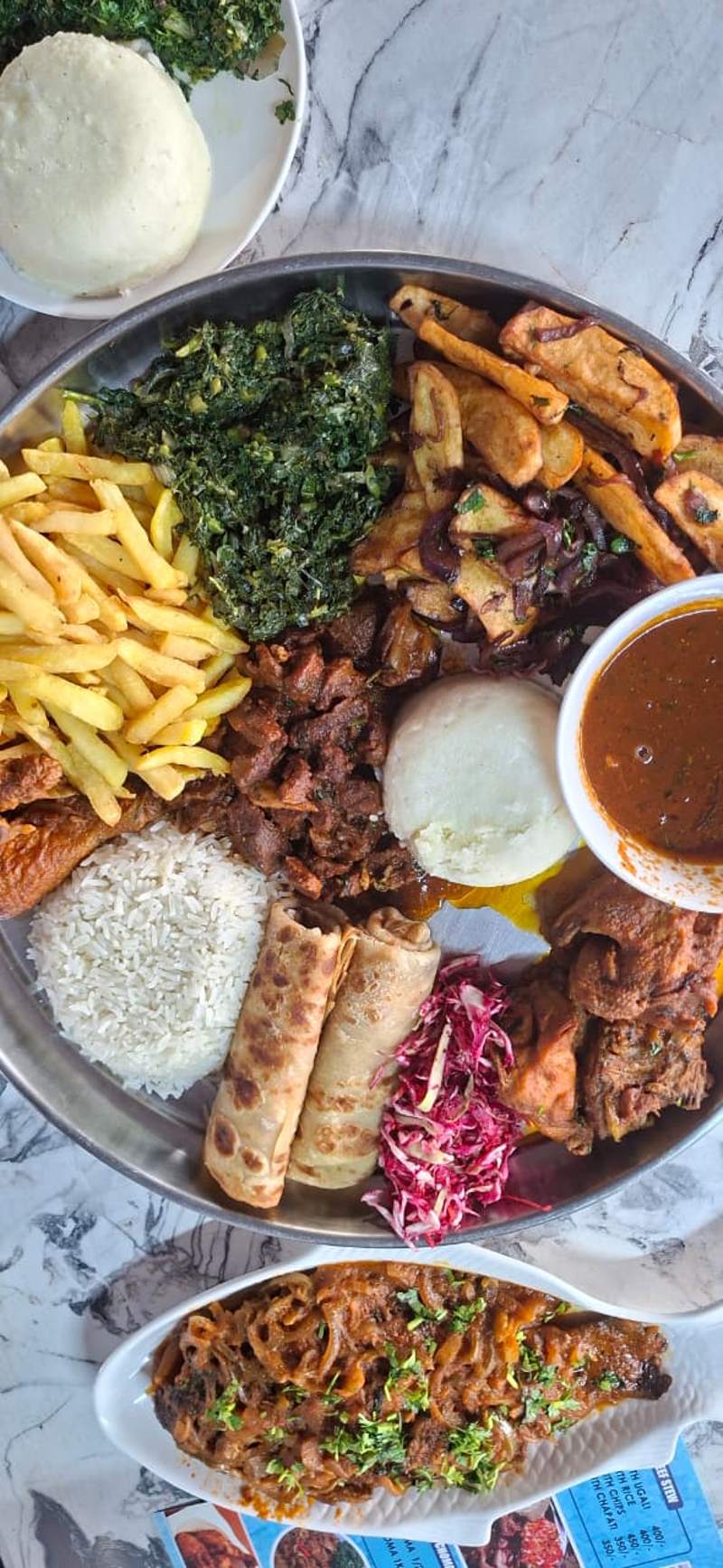 Loaded platter with chips, choma and salad
